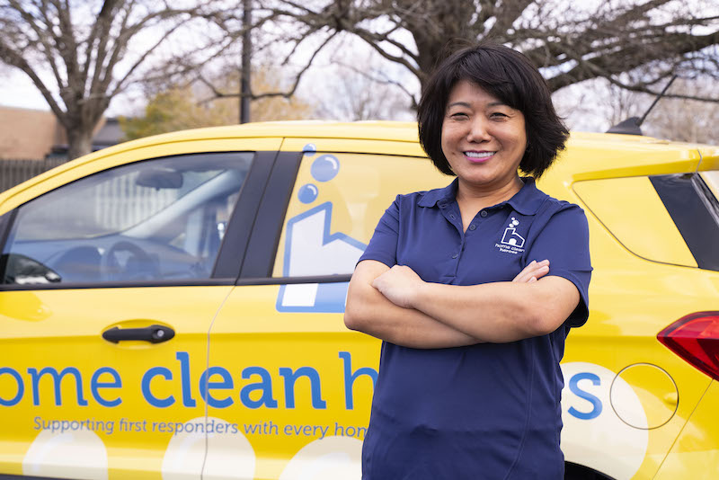 Home Clean Heroes business owner in front of vehicle smiling