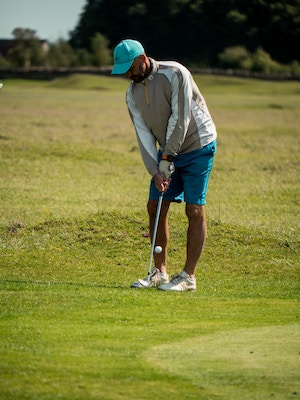 Man swinging golf club on the golf course