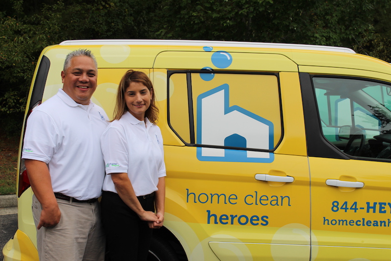 Home Clean Heroes of the Peninsula owners standing in front of van