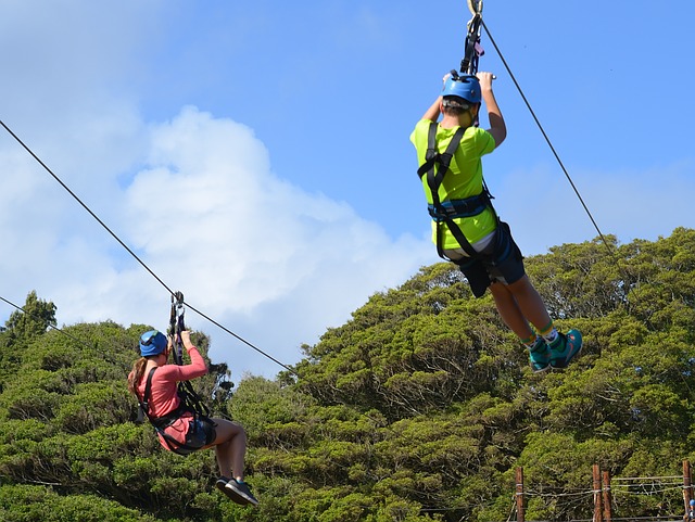Man and woman ziplining on a sunny day