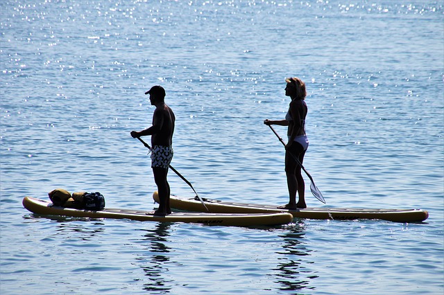 Man and woman paddleboarding in Great Neck, Virginia Beach