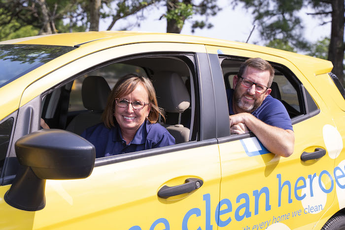 Home Clean Heroes of West Fort Worth Owners Shawn and Anthony in a Home Clean Heroes vehicle