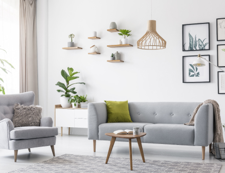 Clean bright living room with grey couch and chair