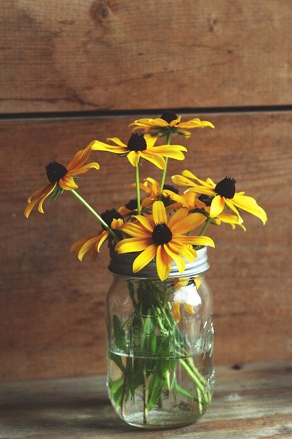 Sunflowers in a mason jar on wooden table