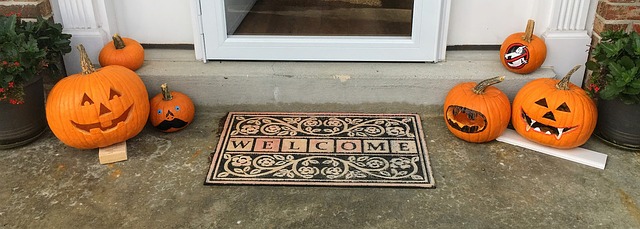 Front door with Welcome mat and pumpkins