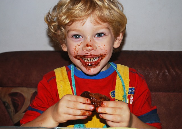 Little boy with chocolate covering his mouth and hands