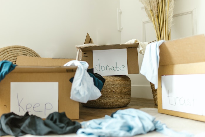 Sorting clothes into a Donate and Keep box