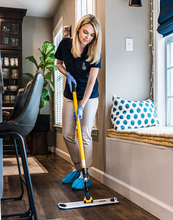 House cleaner cleaning floors to remove dirt and grime